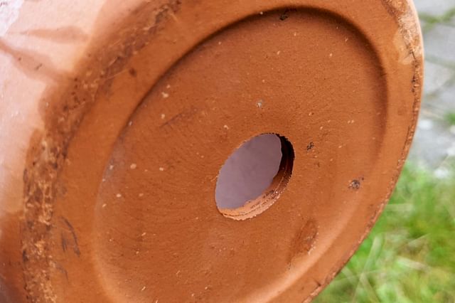 Drainage hole in a terra cotta pot