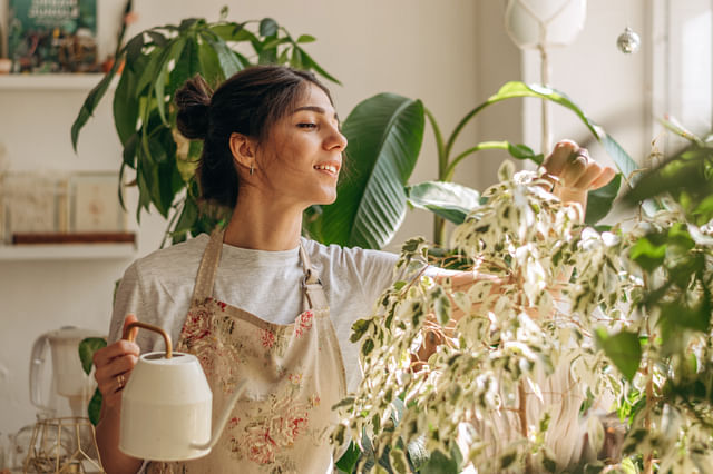 Happy plant owner with a watering can